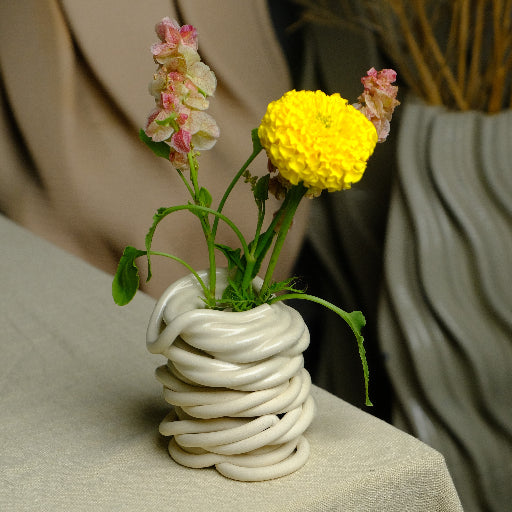 ceramic coiled vase with yellow and pink flowers #color_white
