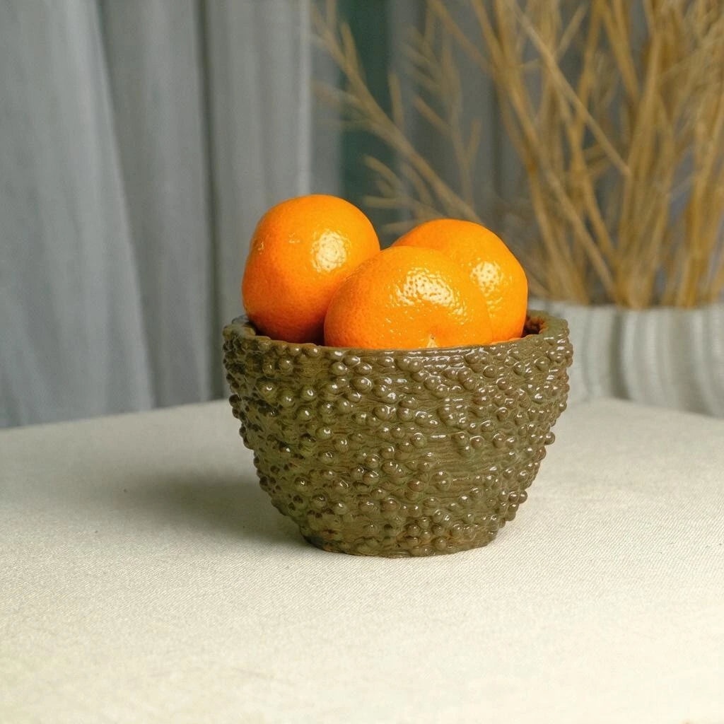 Ceramic fruit bowl filled with oranges design reimagined as a sculptural decorative piece #color_olive green
