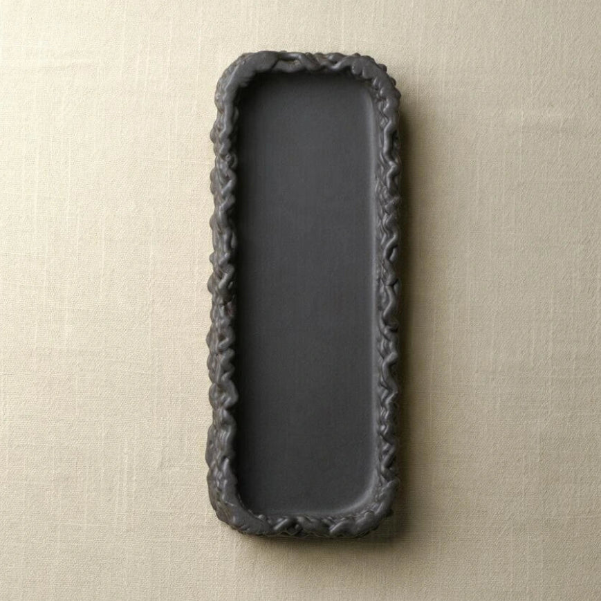 Vertical top-down flat lay of an empty matte black 3D printed ceramic vanity tray on linen fabric #color_black