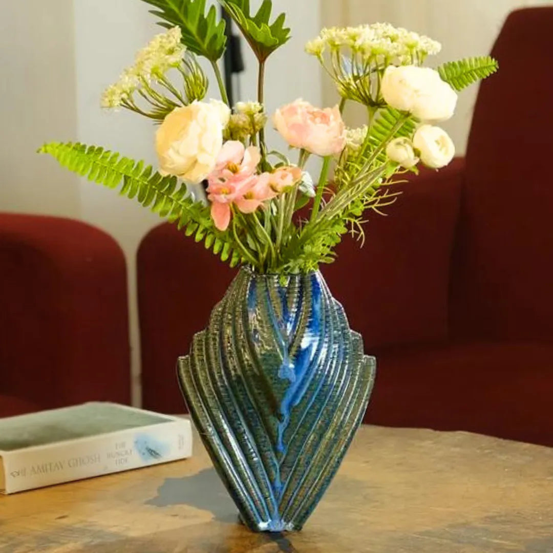 Blue unique ceramic vase with flowers styled in a living room #color_sapphire blue